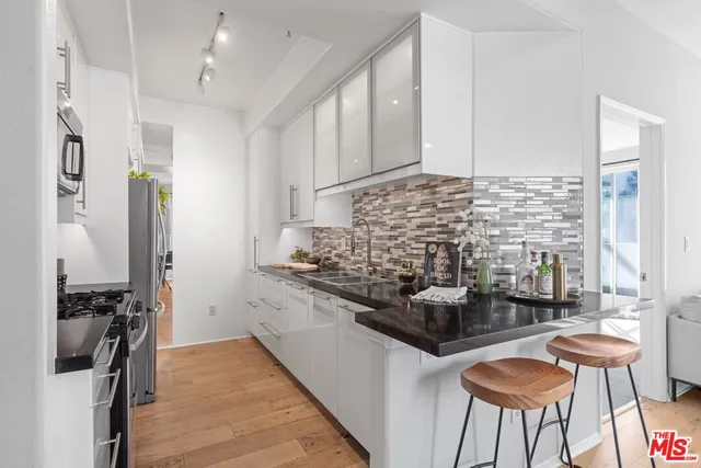 a kitchen with stainless steel appliances granite countertop a stove and a refrigerator