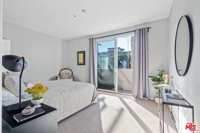 a bedroom with bed and a chandelier