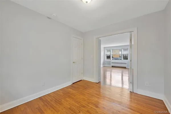 a view of hallway with wooden floor
