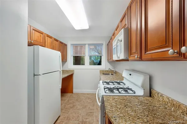 a kitchen with a stove a sink and a refrigerator