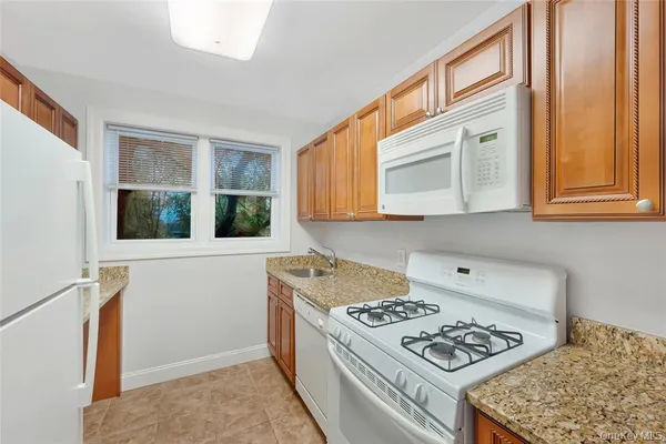 a kitchen with stainless steel appliances granite countertop a refrigerator and a stove