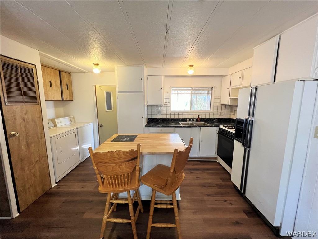 171 South Houck Road Golden Valley, AZ 86413 - Photo 7 of 36 a kitchen with stainless steel appliances a refrigerator a stove a sink a dining table and chairs