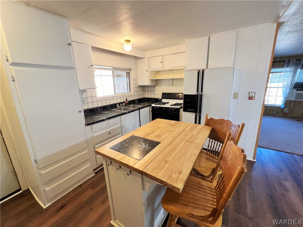171 South Houck Road Golden Valley, AZ 86413 - Photo 8 of 36 a kitchen with a sink a stove a refrigerator and wooden floor