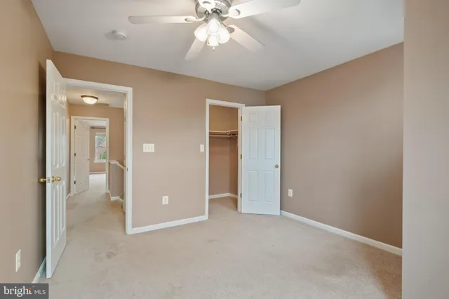 an empty room with fan and entrance