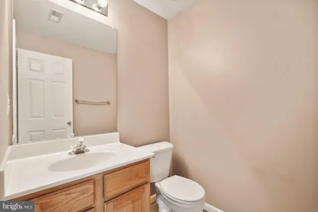 a bathroom with a sink a toilet and vanity