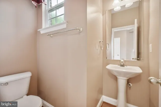 a bathroom with a sink mirror and toilet