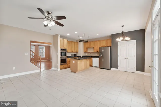 a view of kitchen with refrigerator and microwave
