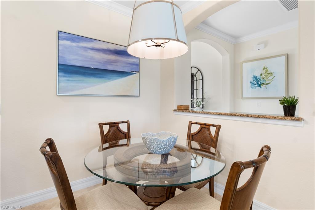 9419 Piacere Way Naples, FL 34113 - Photo 12 of 47 a view of a dining room with furniture and wooden floor