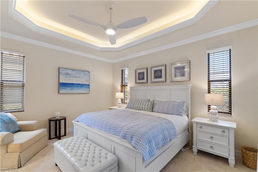 9419 Piacere Way Naples, FL 34113 - Photo 13 of 47 a bedroom with a bed and a chandelier