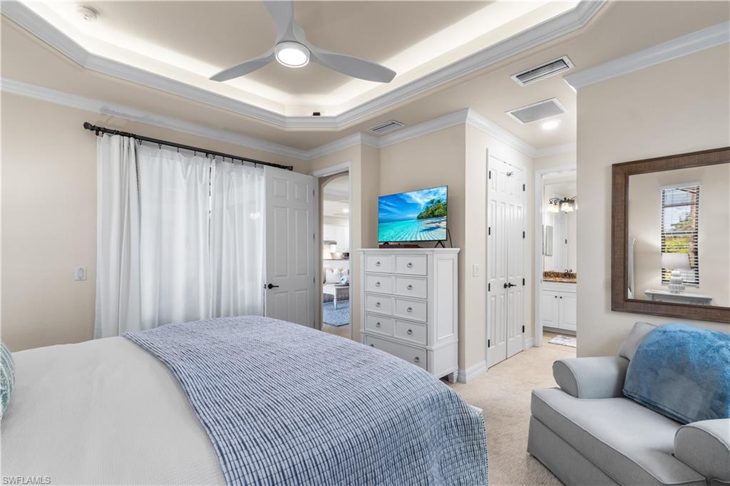 9419 Piacere Way Naples, FL 34113 - Photo 14 of 47 a spacious bedroom with a bed and a couch