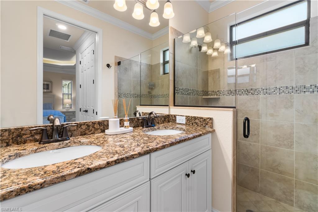 9419 Piacere Way Naples, FL 34113 - Photo 15 of 47 a bathroom with a granite countertop sink a large mirror and a shower