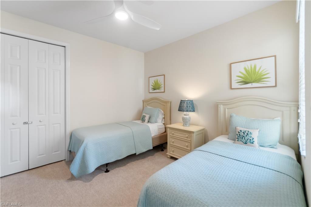 9419 Piacere Way Naples, FL 34113 - Photo 18 of 47 a bedroom with two beds and a painting on the wall