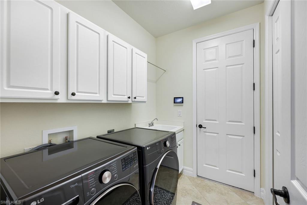 9419 Piacere Way Naples, FL 34113 - Photo 19 of 47 a room with storage and utility