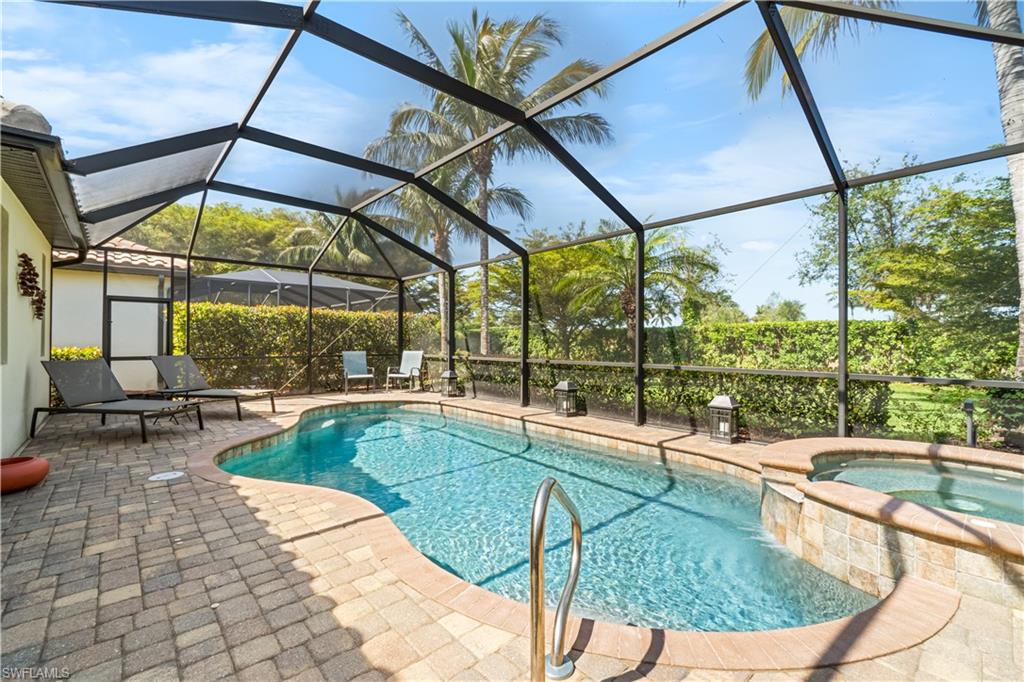 9419 Piacere Way Naples, FL 34113 - Photo 20 of 47 a view of a swimming pool with a patio
