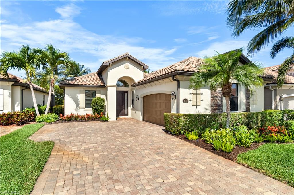 9419 Piacere Way Naples, FL 34113 - Photo 2 of 47 a front view of a house with a garden