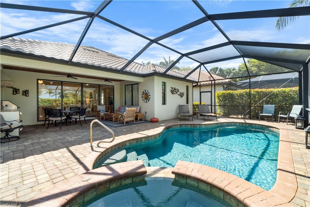 9419 Piacere Way Naples, FL 34113 - Photo 21 of 47 a view of a swimming pool with a patio