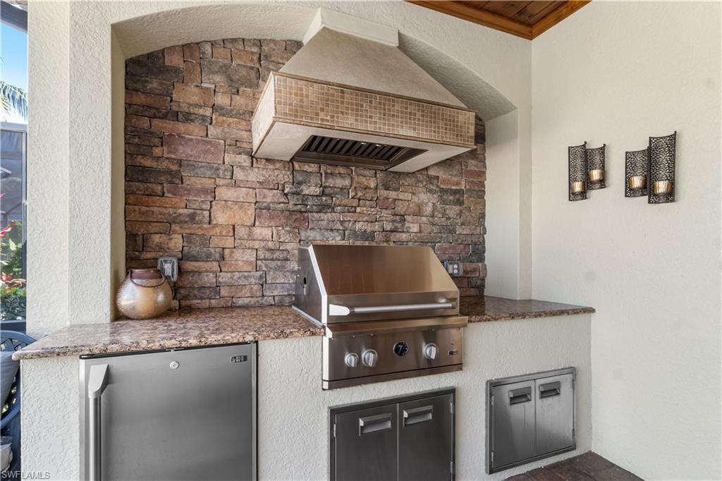 9419 Piacere Way Naples, FL 34113 - Photo 23 of 47 a stove top oven sitting inside of a kitchen