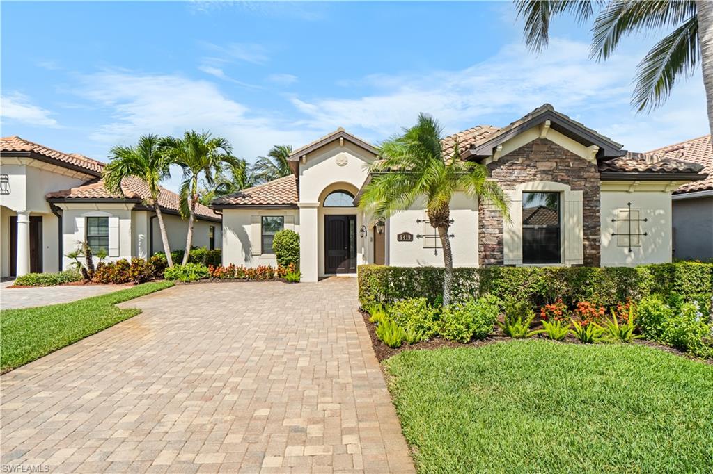 9419 Piacere Way Naples, FL 34113 - Photo 24 of 47 front view of a house with a garden