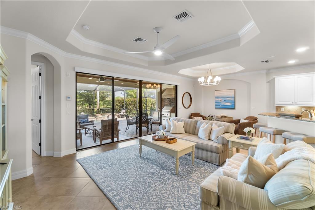 9419 Piacere Way Naples, FL 34113 - Photo 5 of 47 a living room with furniture and a large window