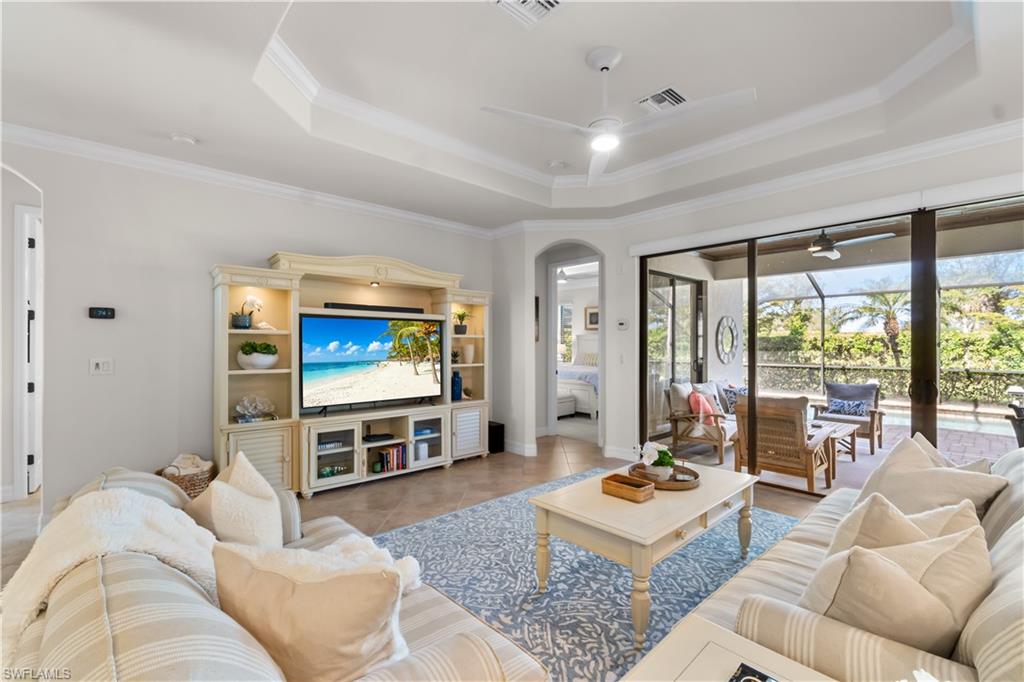 9419 Piacere Way Naples, FL 34113 - Photo 6 of 47 a living room with furniture and a flat screen tv