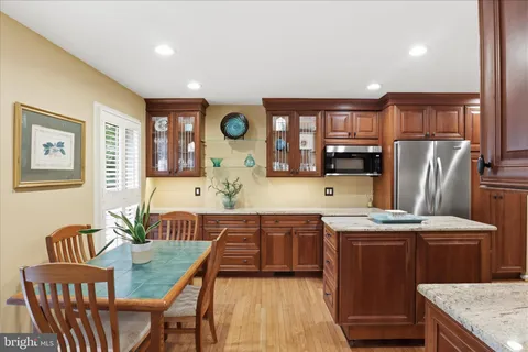 a kitchen with granite countertop a stove a sink and dishwasher wooden cabinets with granite countertops
