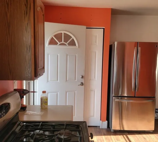 a kitchen with stainless steel appliances granite countertop a refrigerator and a stove top oven