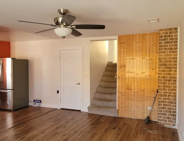 a view of a room with wooden floor and staircase