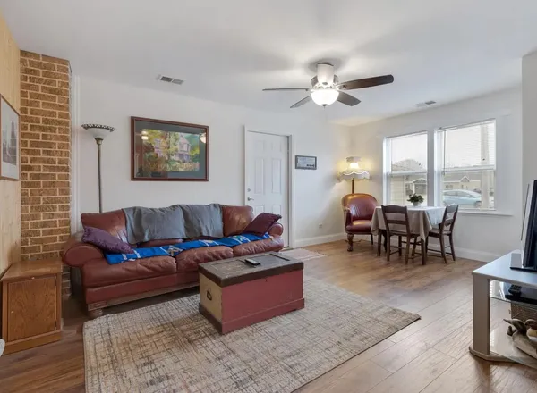 a living room with furniture a fireplace and large windows