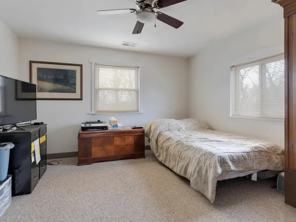 a bedroom with bed and window