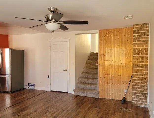 a view of a room with wooden floor and staircase