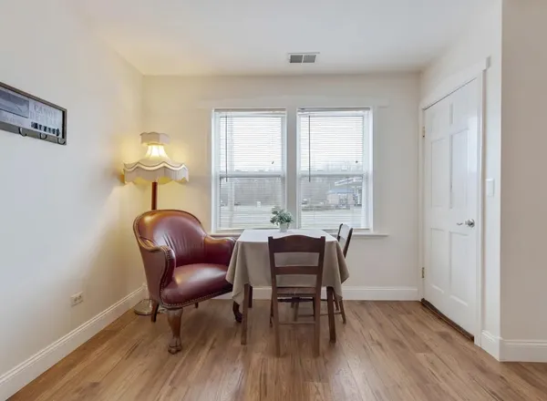 a view of a livingroom with lounge chair and a window