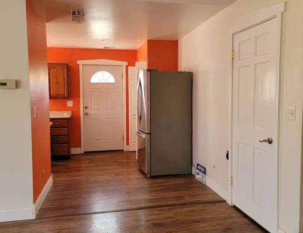 an empty room with wooden floor and closet