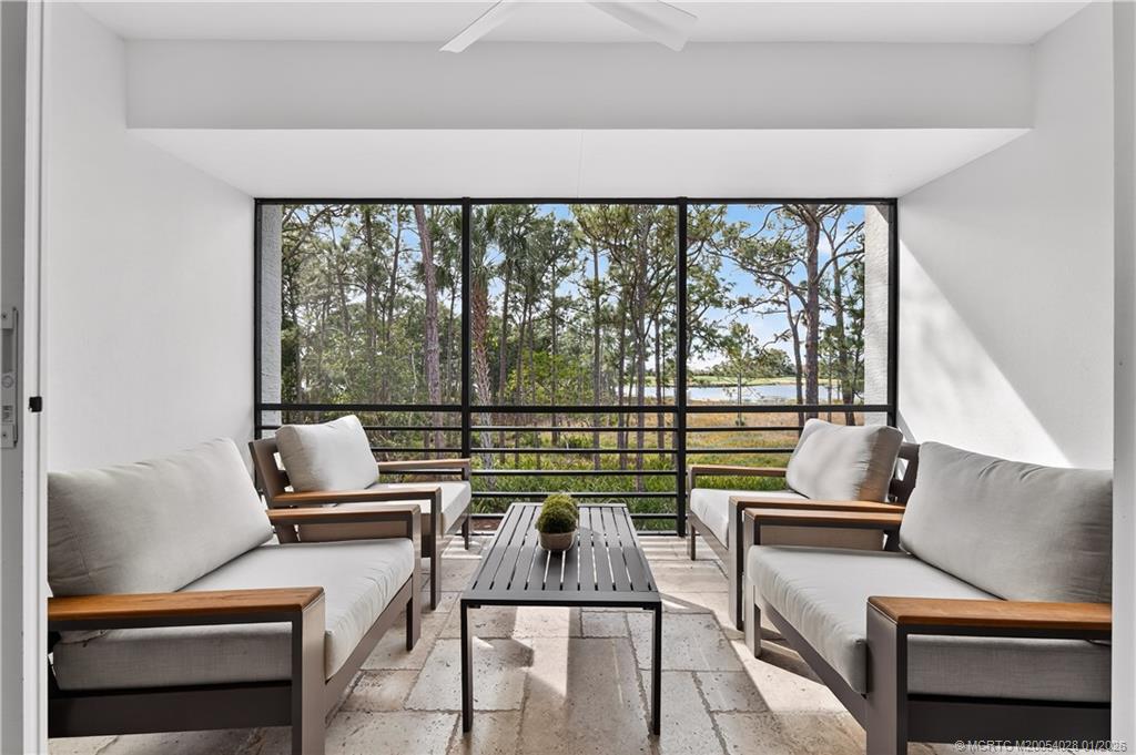 13204 Harbour Ridge Boulevard, Unit 2A Palm City, FL 34990 - Photo 15 of 38 a living room with furniture and a floor to ceiling window