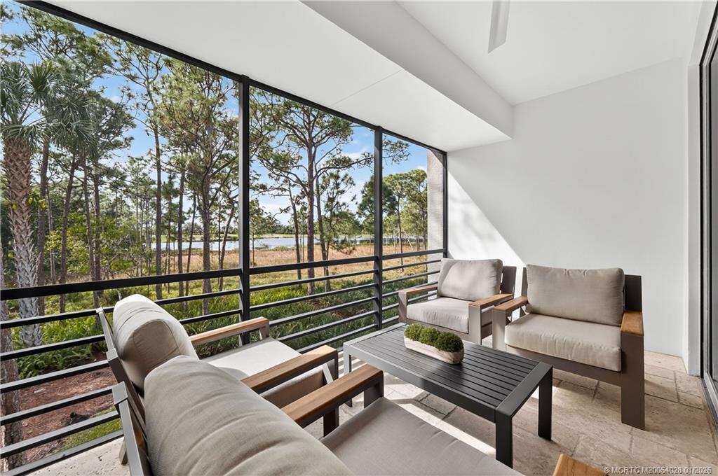 13204 Harbour Ridge Boulevard, Unit 2A Palm City, FL 34990 - Photo 16 of 38 a living room with furniture and a floor to ceiling window