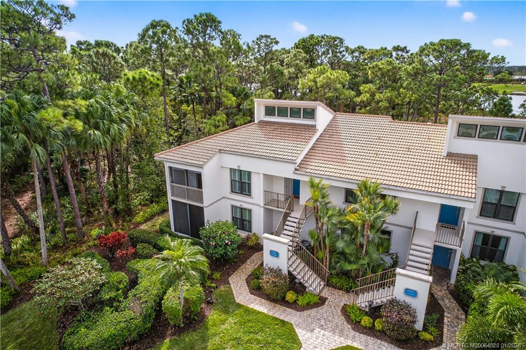 13204 Harbour Ridge Boulevard, Unit 2A Palm City, FL 34990 - Photo 2 of 38 a aerial view of a house with a yard and potted plants