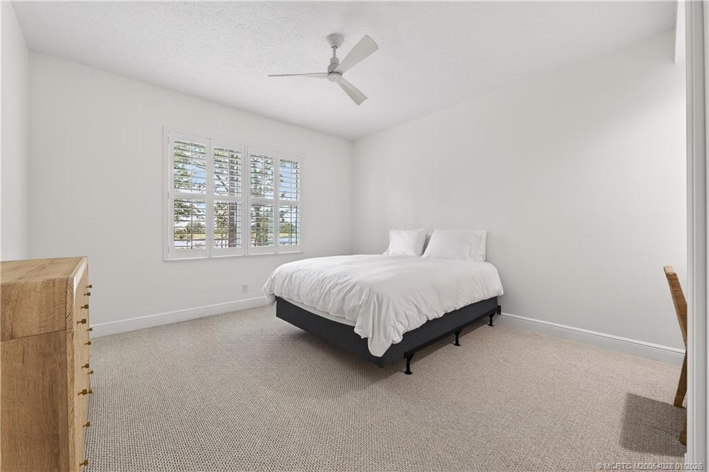 13204 Harbour Ridge Boulevard, Unit 2A Palm City, FL 34990 - Photo 22 of 38 a bedroom with a bed and a window