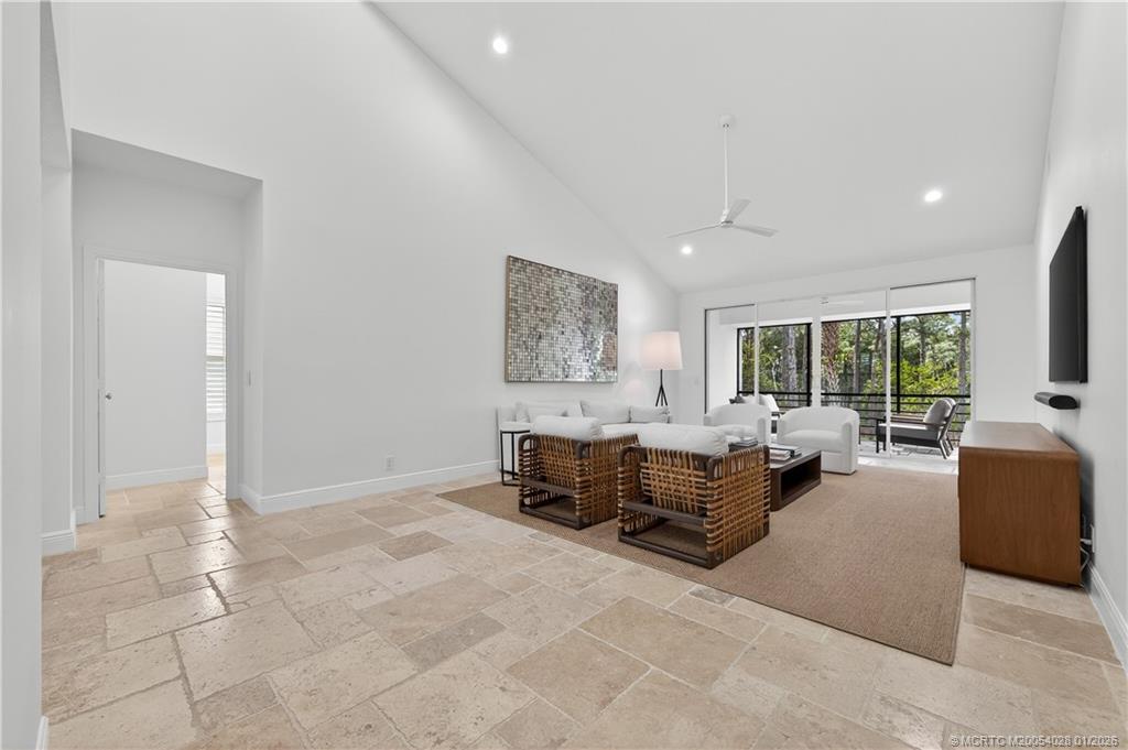 13204 Harbour Ridge Boulevard, Unit 2A Palm City, FL 34990 - Photo 5 of 38 a living room with furniture large window and flat screen tv