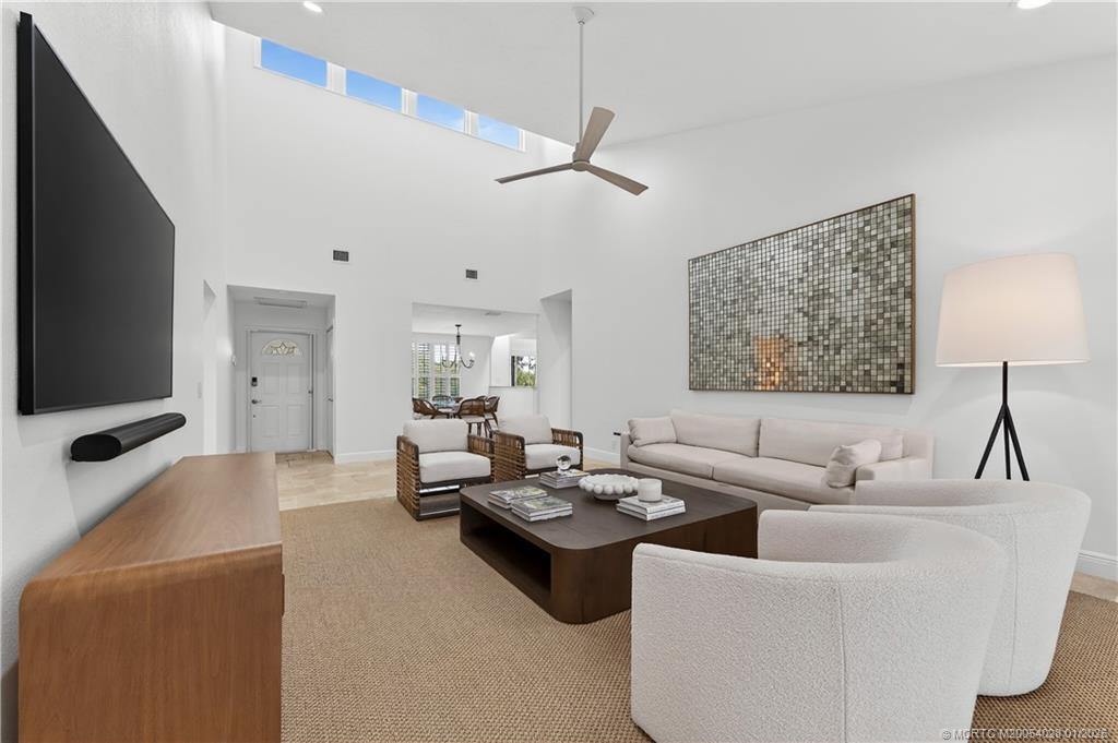 13204 Harbour Ridge Boulevard, Unit 2A Palm City, FL 34990 - Photo 7 of 38 a living room with furniture and a flat screen tv