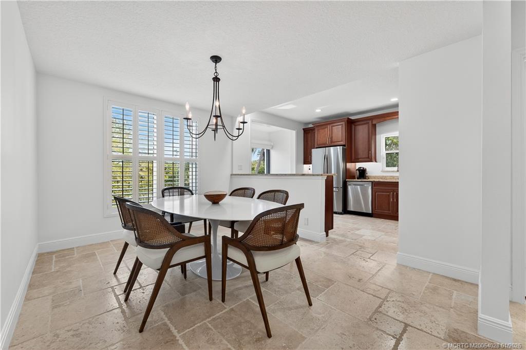 13204 Harbour Ridge Boulevard, Unit 2A Palm City, FL 34990 - Photo 8 of 38 a view of a dining room with furniture window and wooden floor