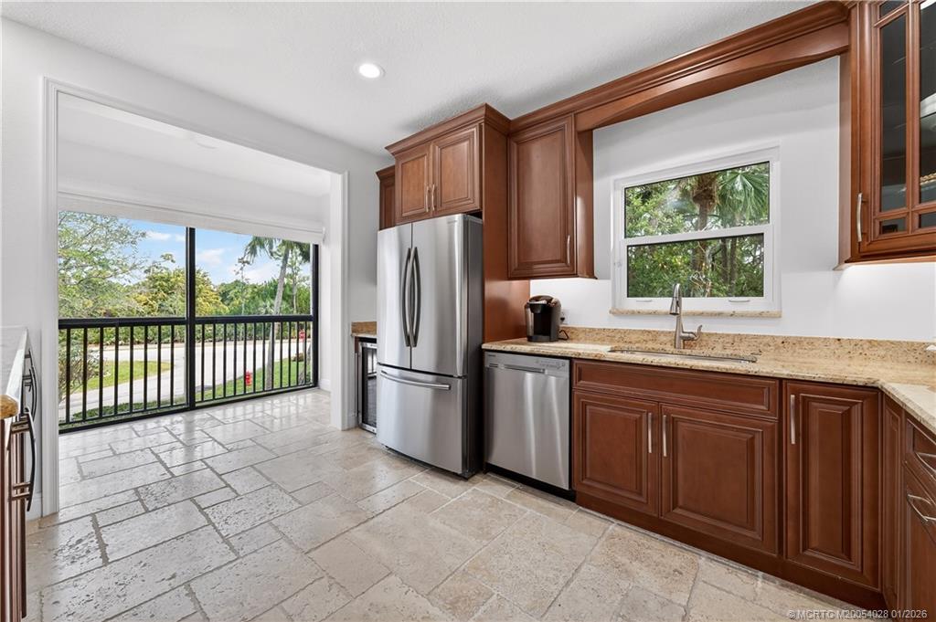 13204 Harbour Ridge Boulevard, Unit 2A Palm City, FL 34990 - Photo 10 of 38 a kitchen with stainless steel appliances granite countertop a refrigerator and a sink