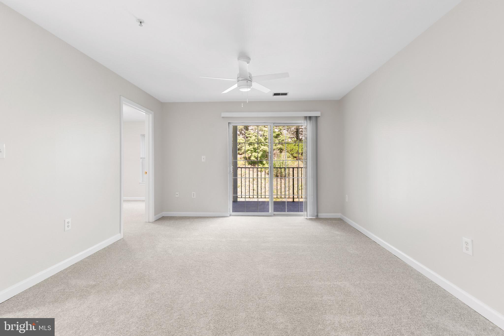 6504 Ridenour Way East, Unit 2C Sykesville, MD 21784 - Photo 16 of 32 an empty room with windows and chandelier