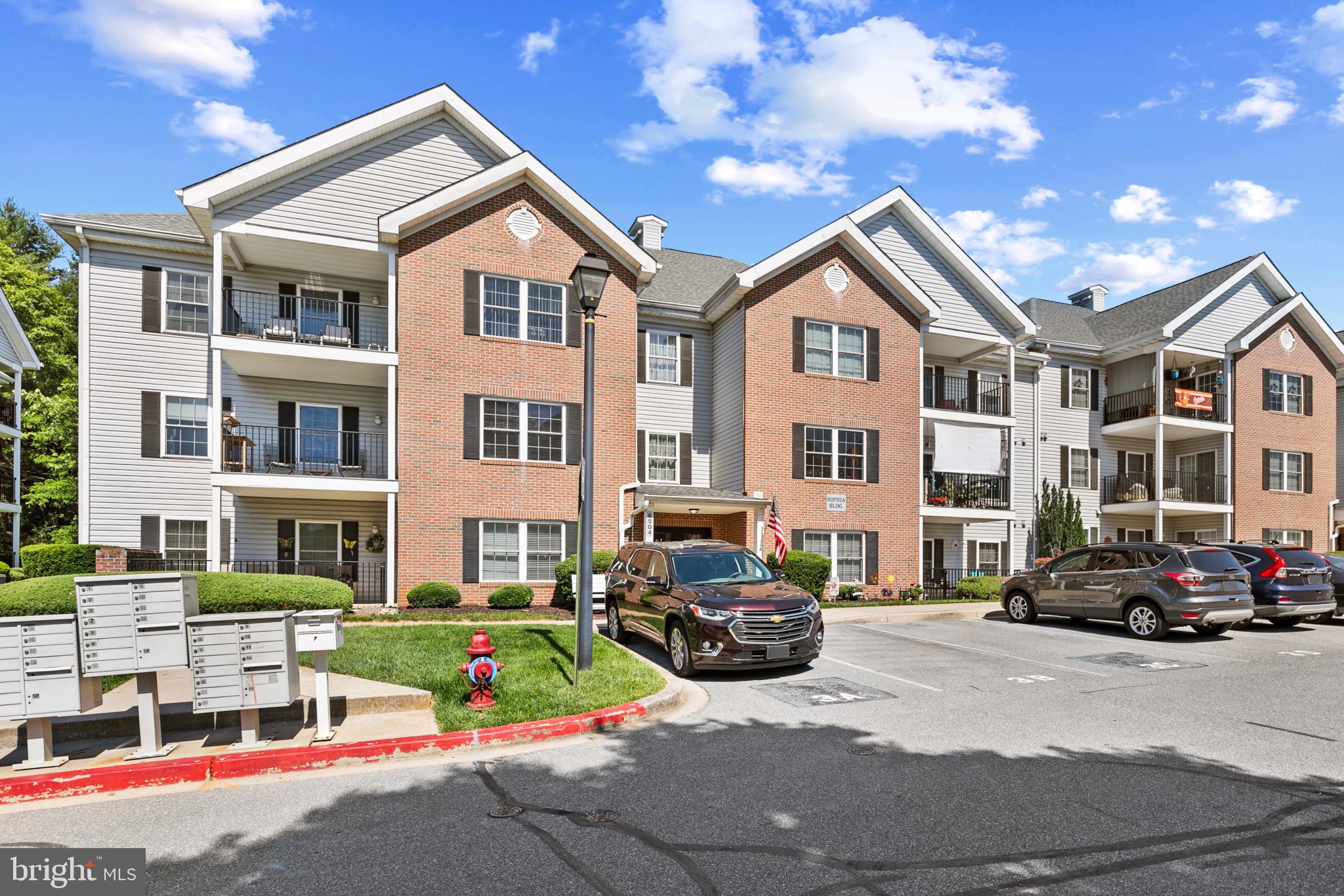 6504 Ridenour Way East, Unit 2C Sykesville, MD 21784 - Photo 2 of 32 a front view of a residential apartment building with a yard