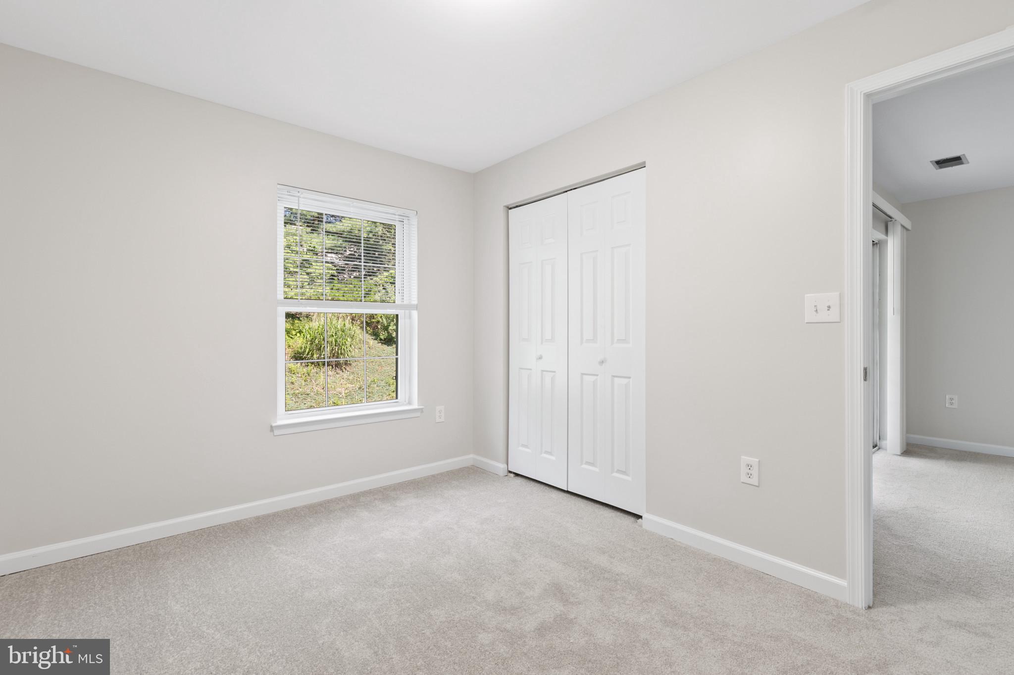 6504 Ridenour Way East, Unit 2C Sykesville, MD 21784 - Photo 28 of 32 a view of an empty room with a window