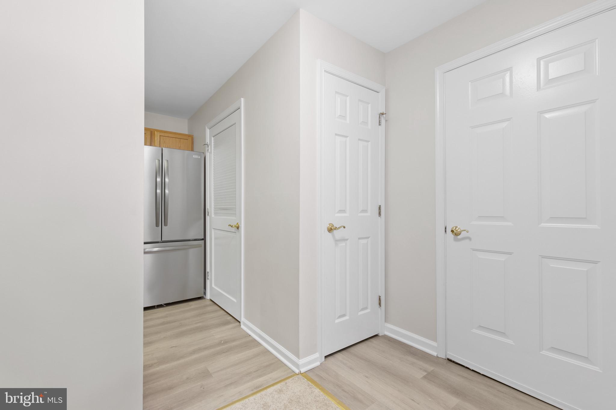 6504 Ridenour Way East, Unit 2C Sykesville, MD 21784 - Photo 3 of 32 a view of a kitchen with a refrigerator and wooden floor