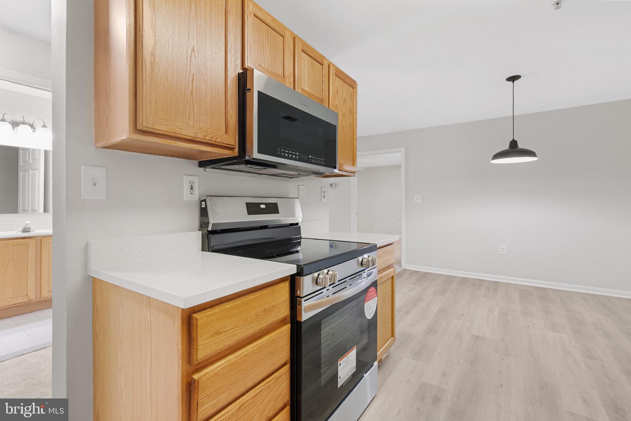 6504 Ridenour Way East, Unit 2C Sykesville, MD 21784 - Photo 9 of 32 a kitchen with a stove and a microwave