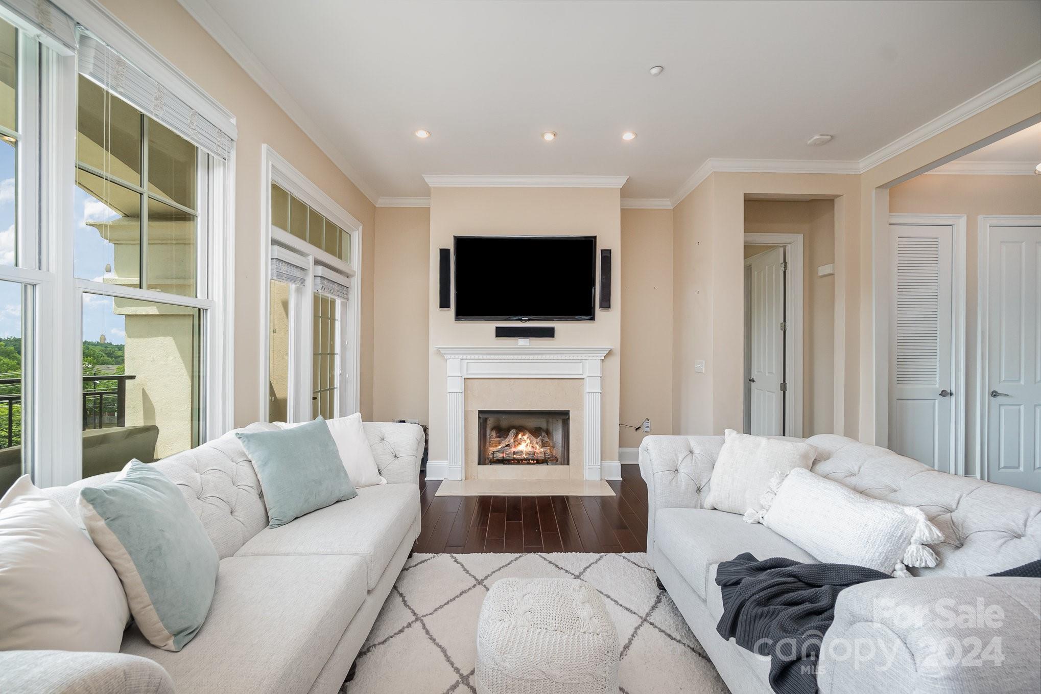 5425 Closeburn Road, Unit 213 Charlotte, NC 28210 - Photo 11 of 32 a living room with furniture a fireplace and a flat screen tv