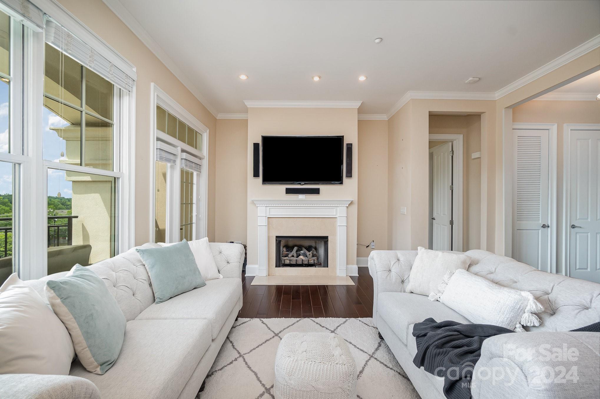 5425 Closeburn Road, Unit 213 Charlotte, NC 28210 - Photo 12 of 32 a living room with furniture a fireplace and a flat screen tv