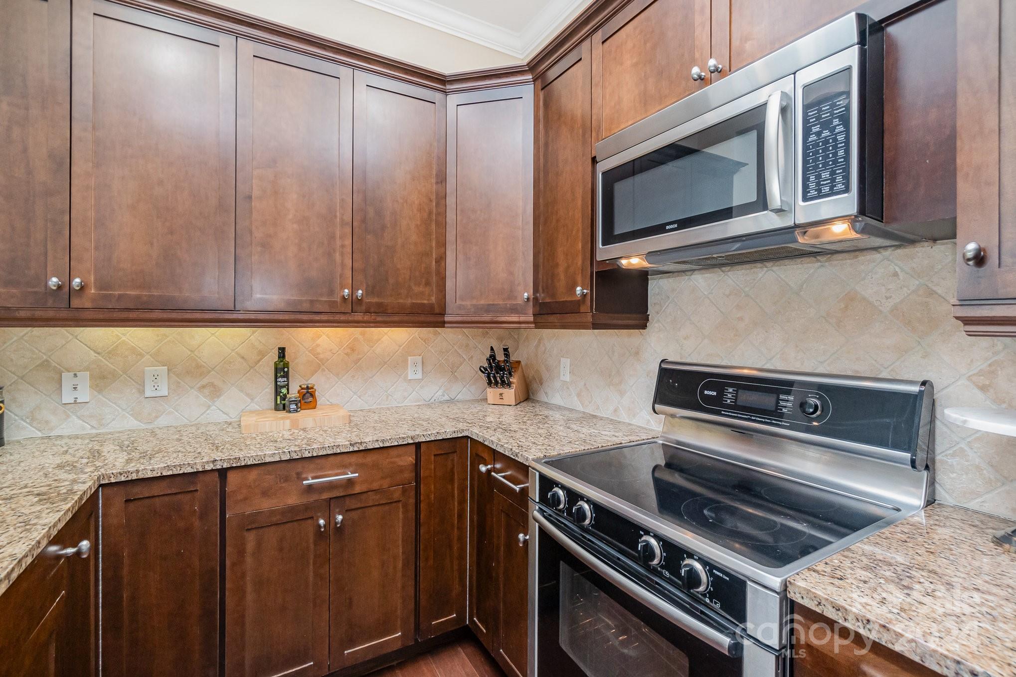 5425 Closeburn Road, Unit 213 Charlotte, NC 28210 - Photo 15 of 32 a kitchen with a stove microwave and sink