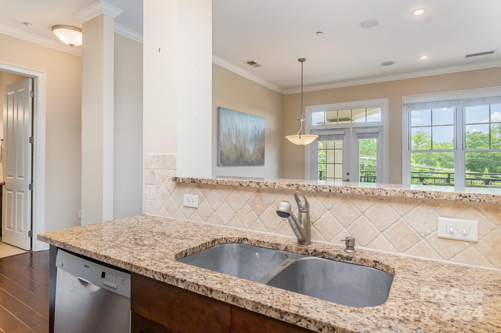 5425 Closeburn Road, Unit 213 Charlotte, NC 28210 - Photo 17 of 32 a kitchen with a sink and a large mirror next to a window