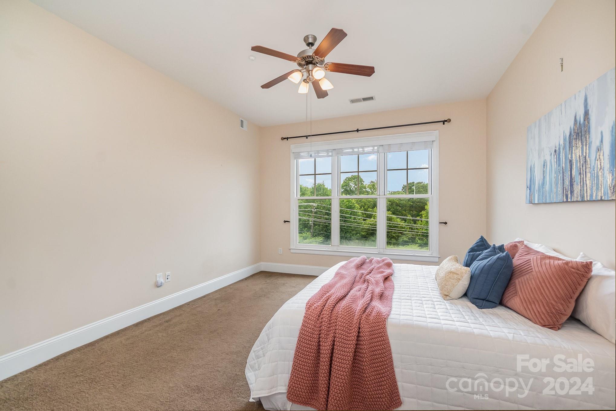 5425 Closeburn Road, Unit 213 Charlotte, NC 28210 - Photo 18 of 32 a bed sitting in a bedroom next to a window
